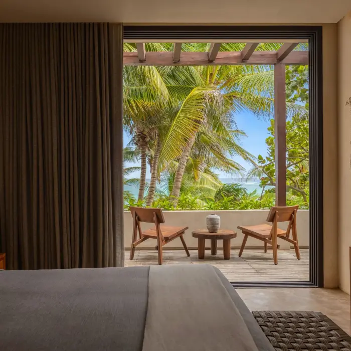 Two cozy bedrooms with tropical decor, soft lighting, and views of the surrounding nature.