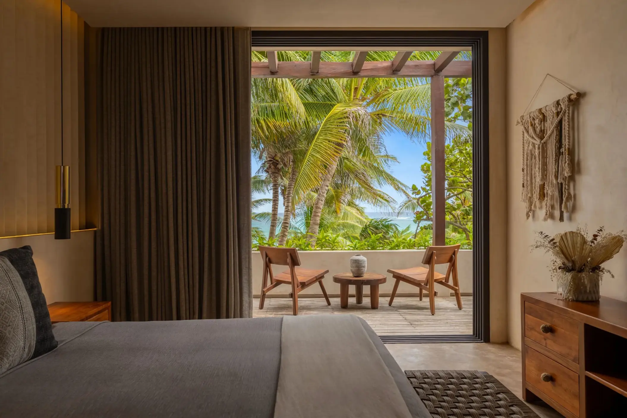 Two cozy bedrooms with tropical decor, soft lighting, and views of the surrounding nature.