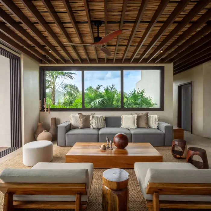 Indoor dining area with rustic wood table, open layout, and contemporary tropical accents.