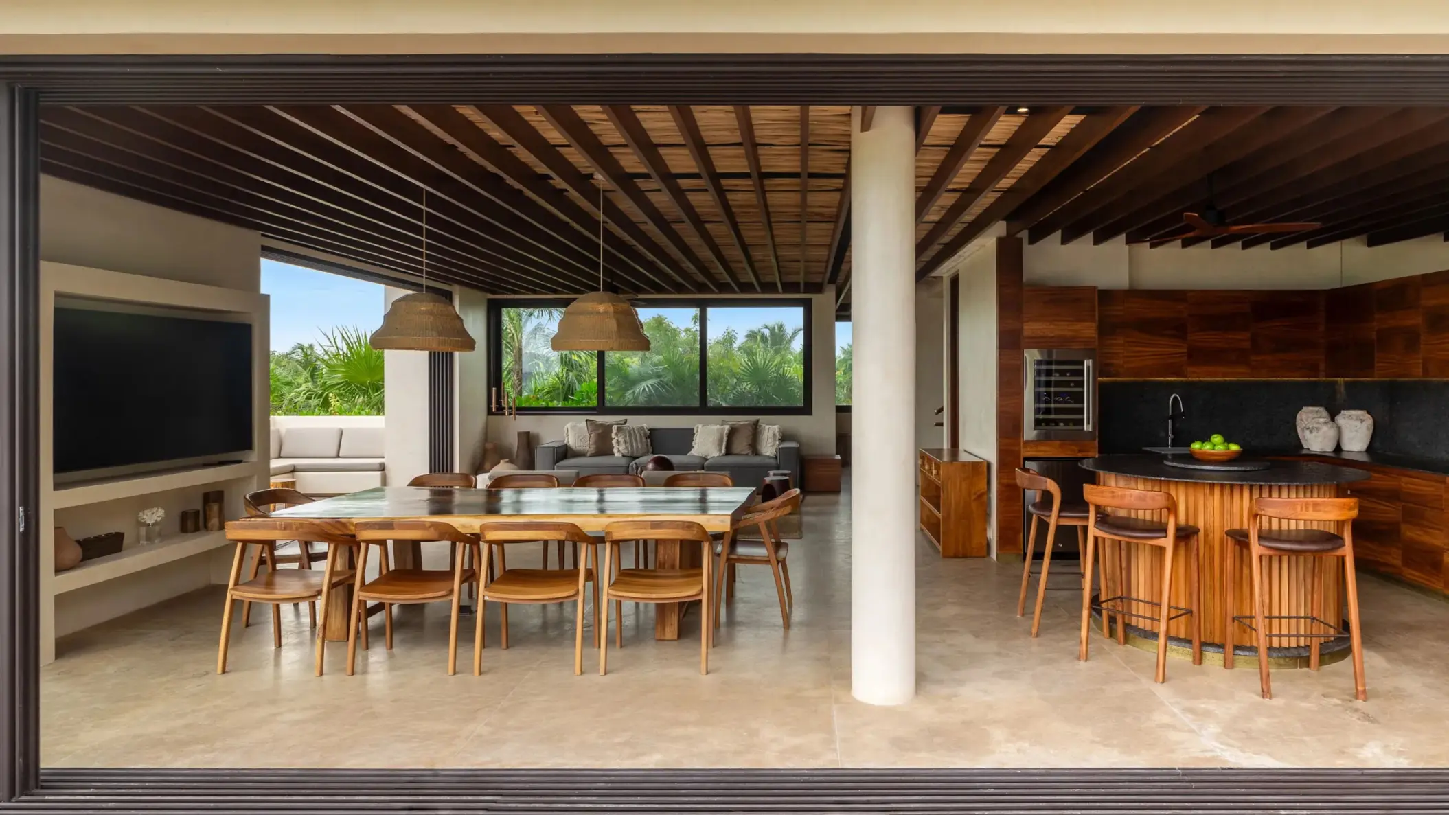 Spacious villa kitchen with natural wood cabinets, premium appliances, and tropical garden views.