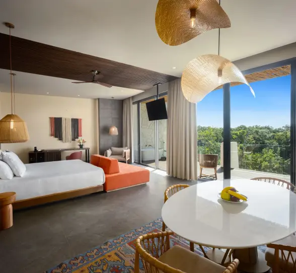 Master suite with king bed, flat-screen TV, and warm, earthy tones inspired by nature.