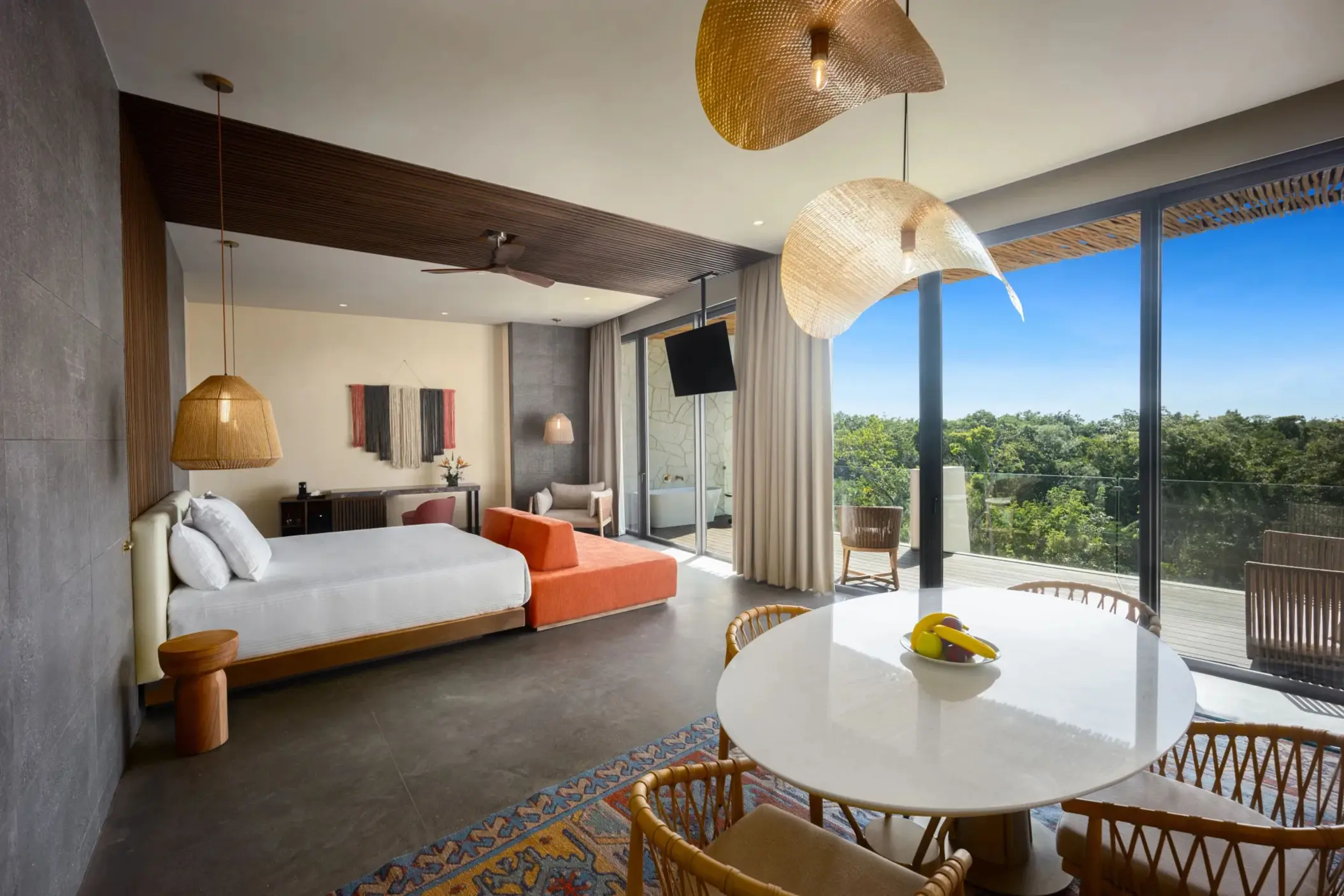Master suite with king bed, flat-screen TV, and warm, earthy tones inspired by nature.