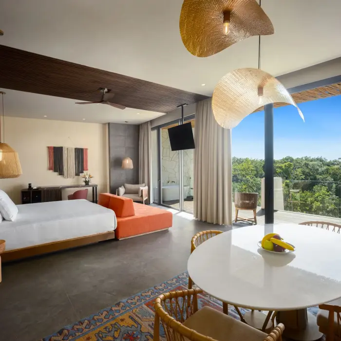 Master suite with king bed, flat-screen TV, and warm, earthy tones inspired by nature.