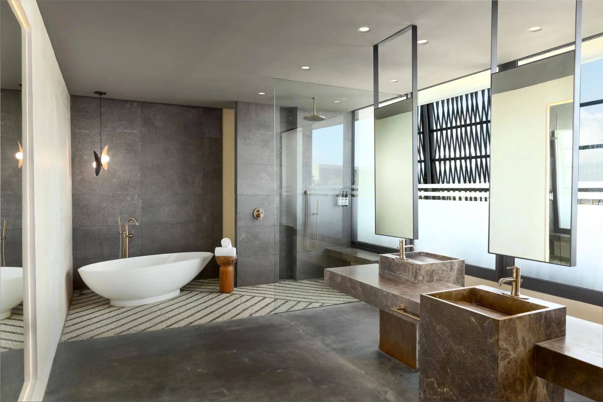 Luxurious bathroom with soaking tub, walk-in shower, and private plunge pool just beyond the glass.