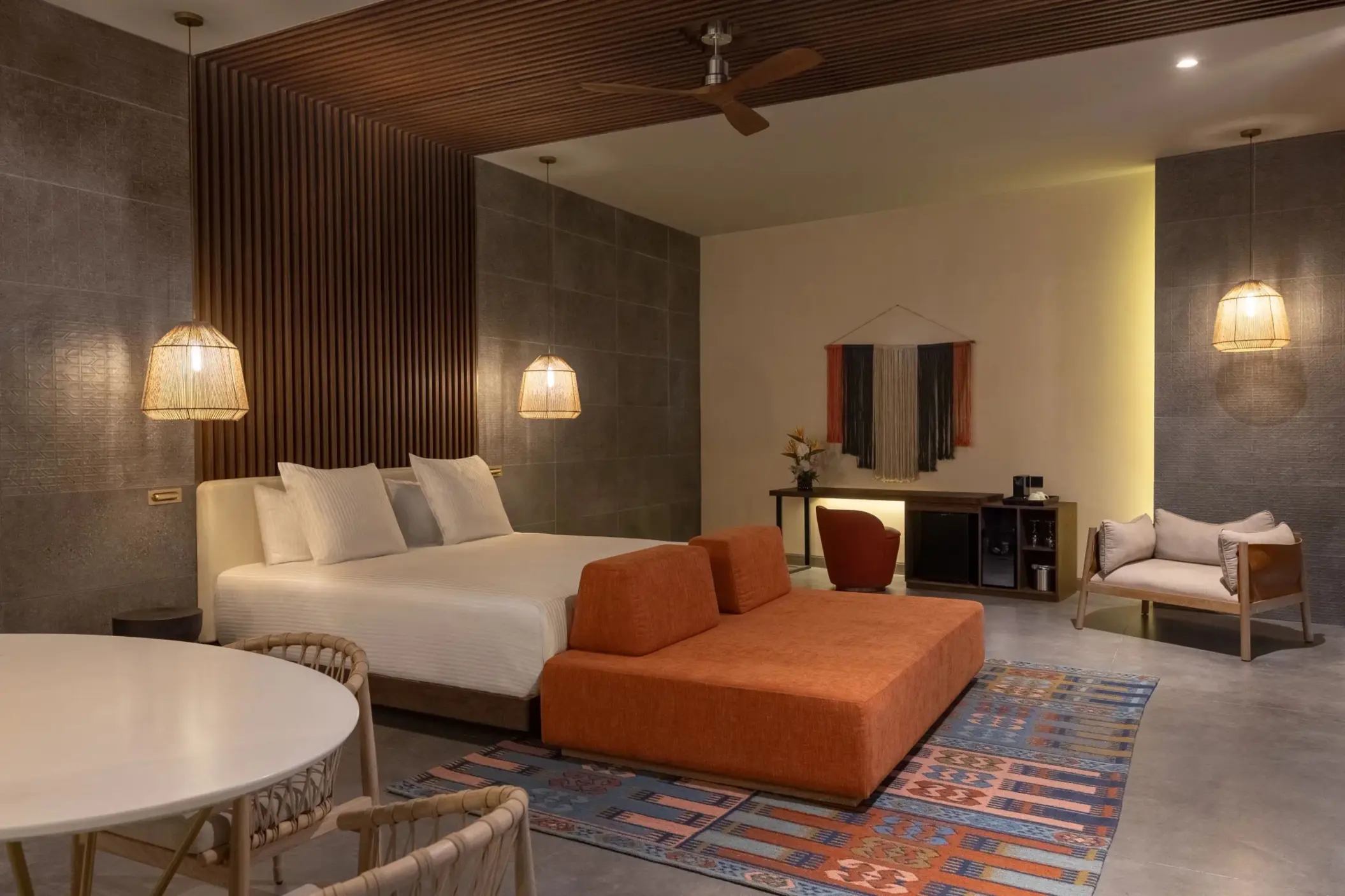 Elegant rooftop suite bedroom with minimalist design, canopy bed, and sliding doors to outdoor area.