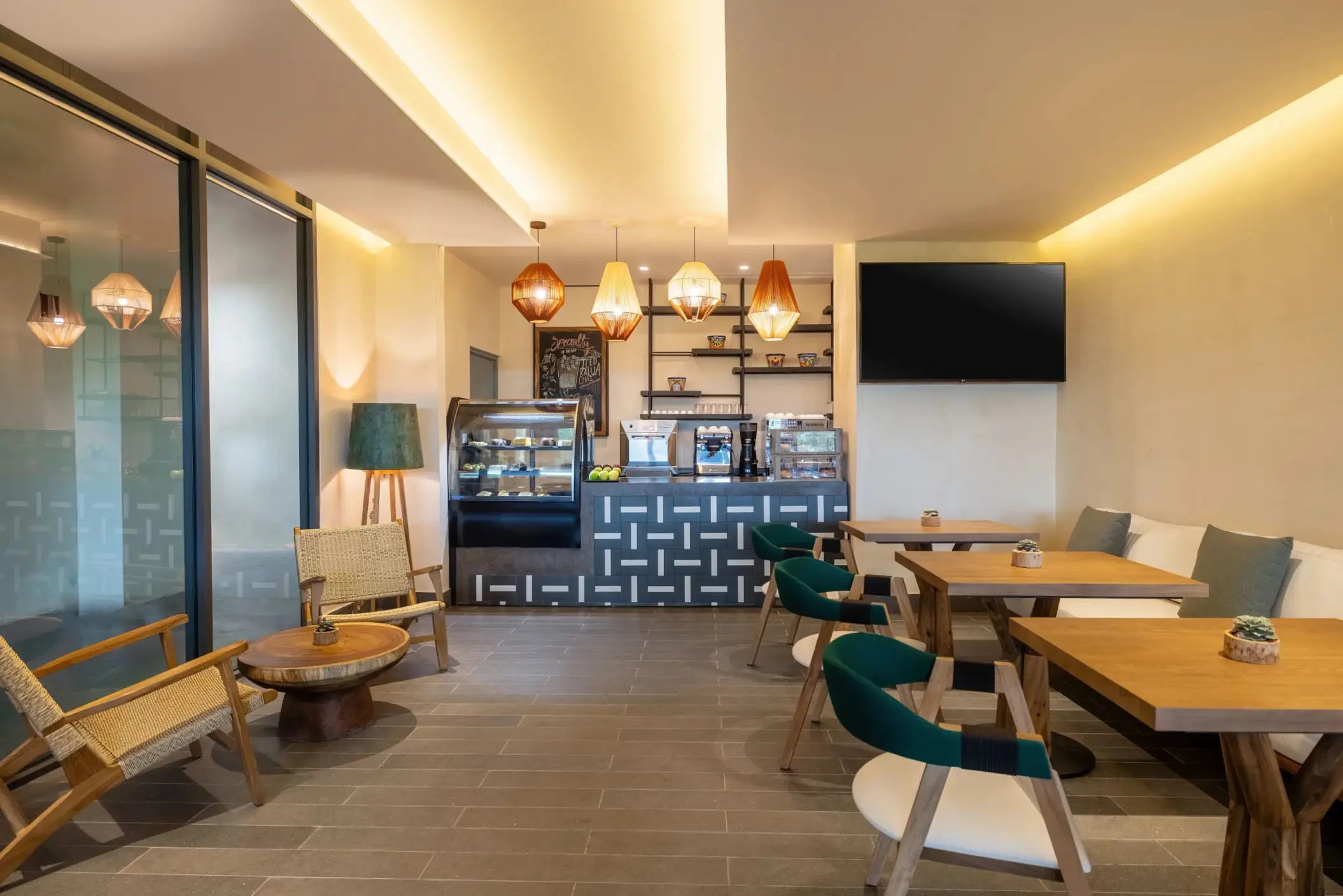 Cozy Coco Café with modern counters, warm lighting, and sweet pastries displayed behind glass.