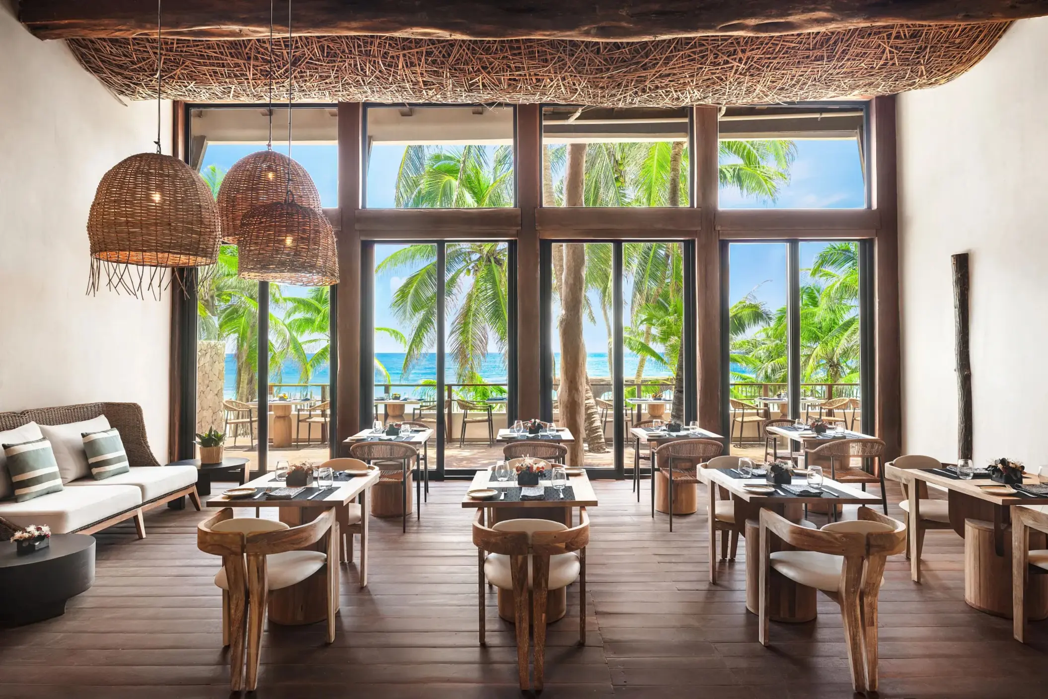 Stylish Rosewater restaurant at Casa Zamna with lush surroundings and upscale jungle aesthetic.