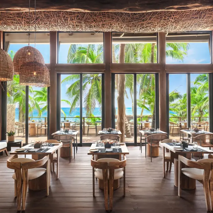 Stylish Rosewater restaurant at Casa Zamna with lush surroundings and upscale jungle aesthetic.