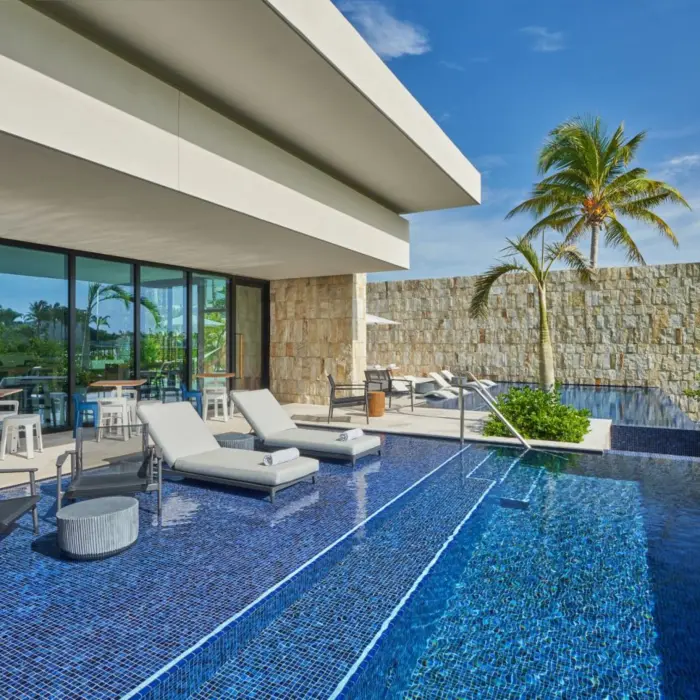 pool with loungers at St. Regis Kanai Resort Riviera Maya