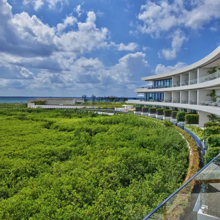 St. Regis Kanai Resort suite balconies with view of the forest and sea in the morning