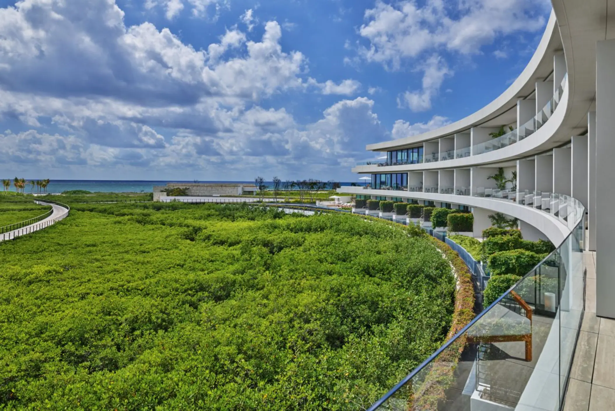 St. Regis Kanai Resort suite balconies with view of the forest and sea in the morning