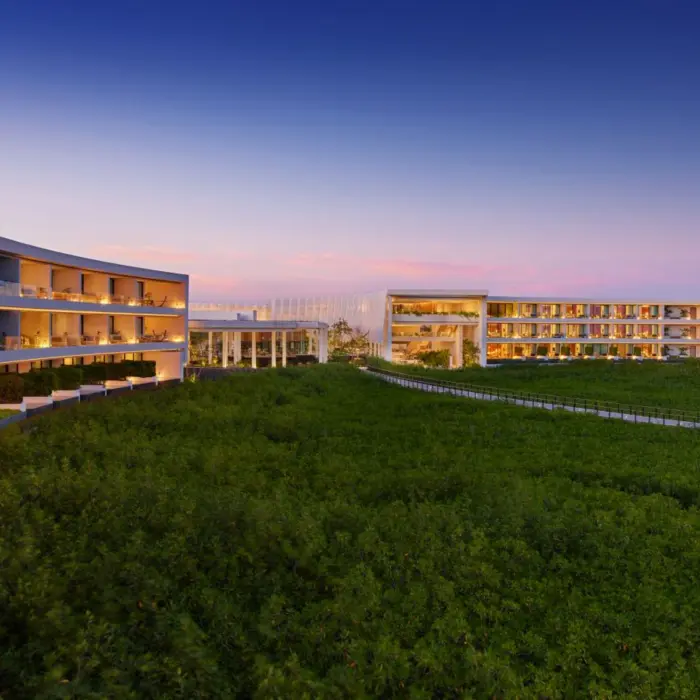 St. Regis Kanai Resort suite balconies with view of the forest in the evening