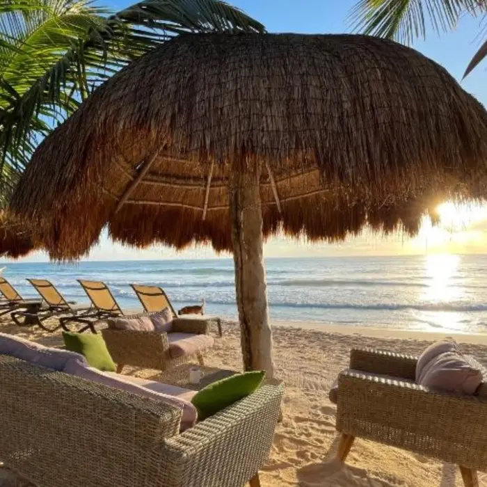 beach loungers and palapa at Suenos Tulum