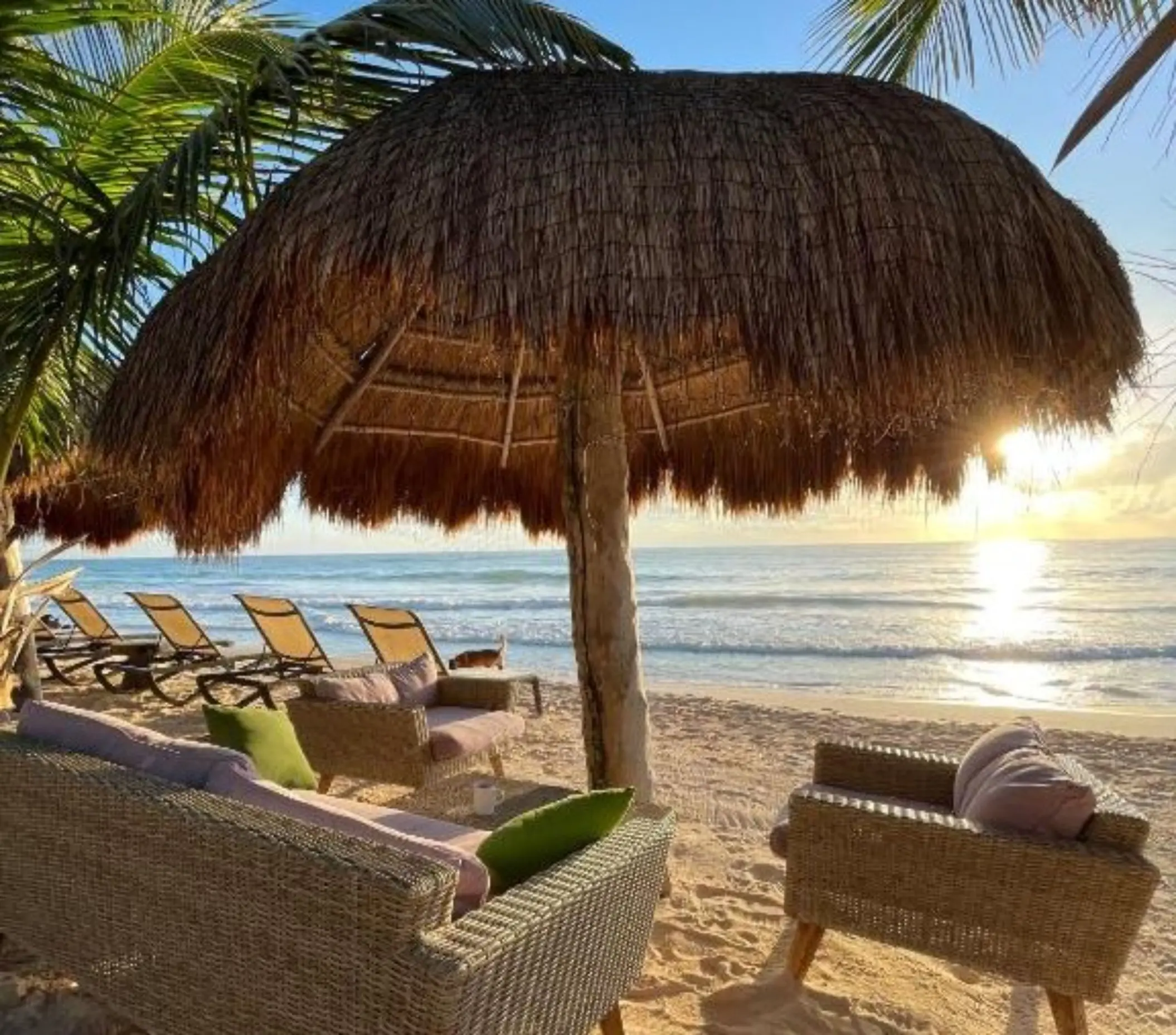 beach loungers and palapa at Suenos Tulum