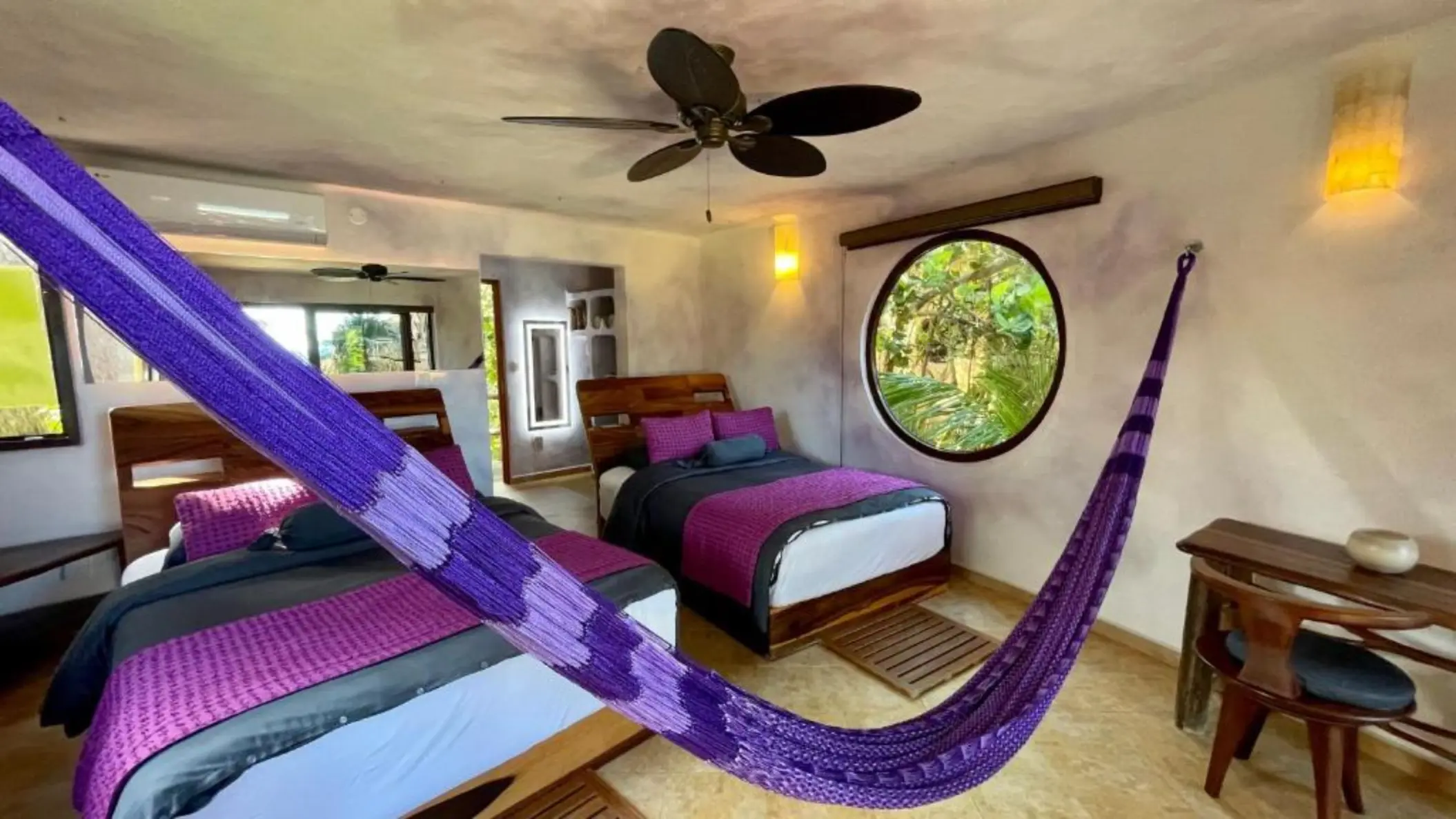 suite with two beds and a hammock at Suenos Tulum
