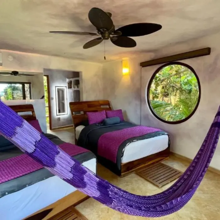 suite with two beds and a hammock at Suenos Tulum