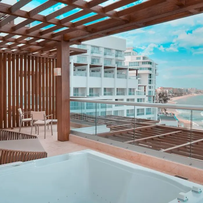 balcony of suite with ocean views and hot tub at Sun Palace Cancun