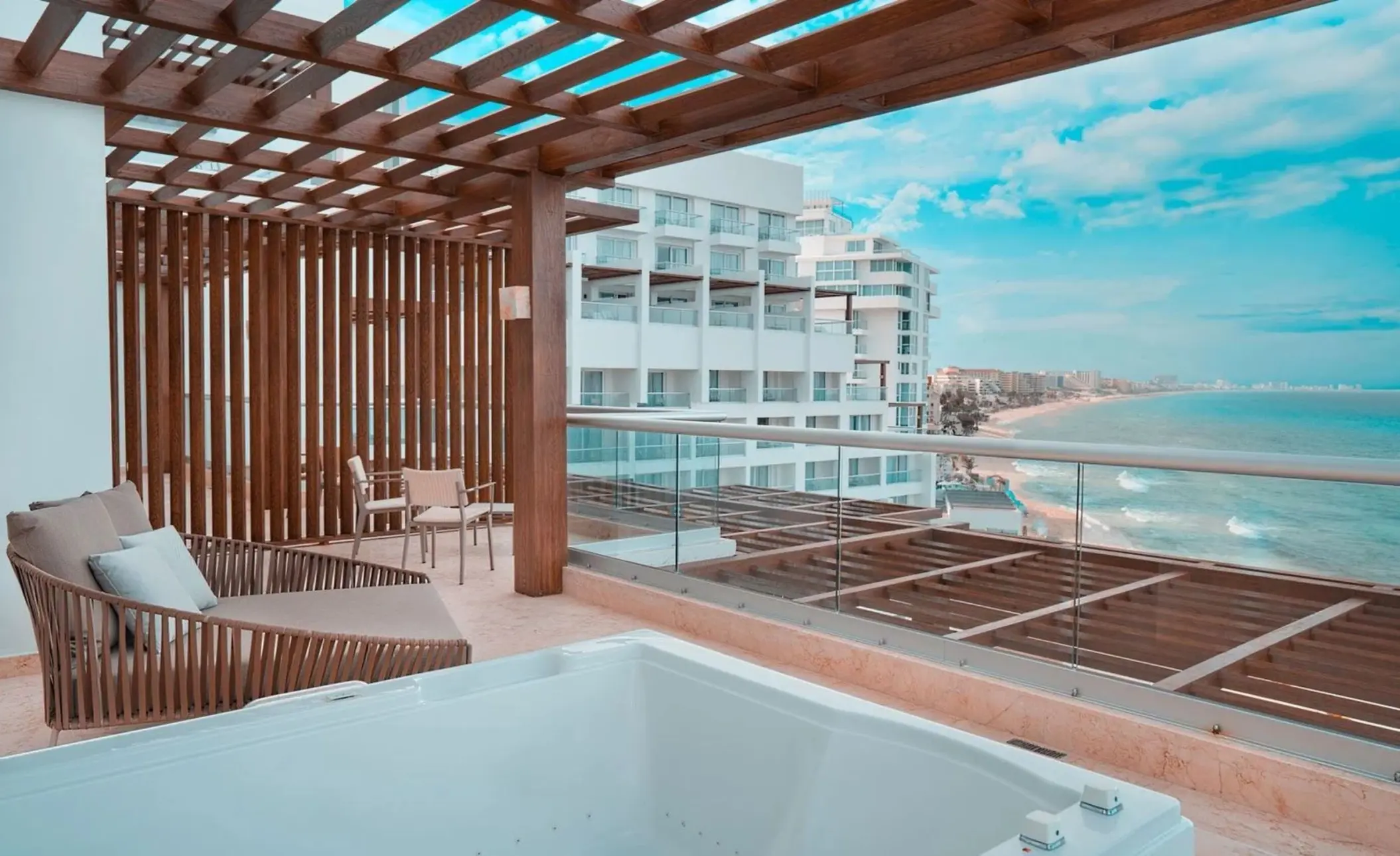 balcony of suite with ocean views and hot tub at Sun Palace Cancun
