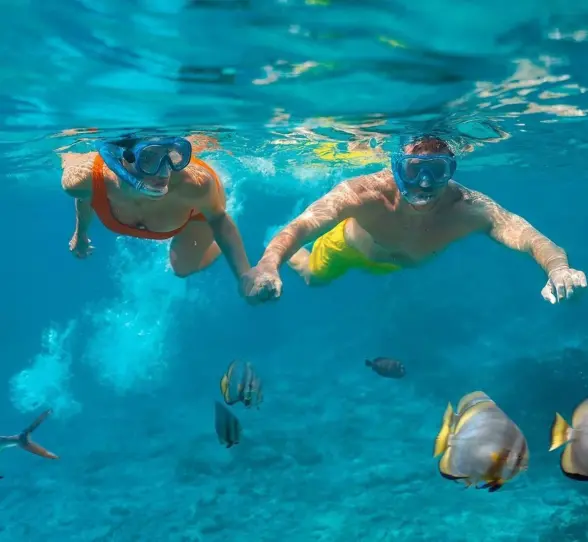 couple snorkeling at Sun Palace Cancun