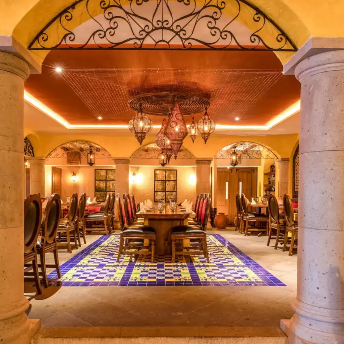 The interior of a Mexican restaurant, Casa De Rosa, featuring ornate columns and colorful tile flooring.