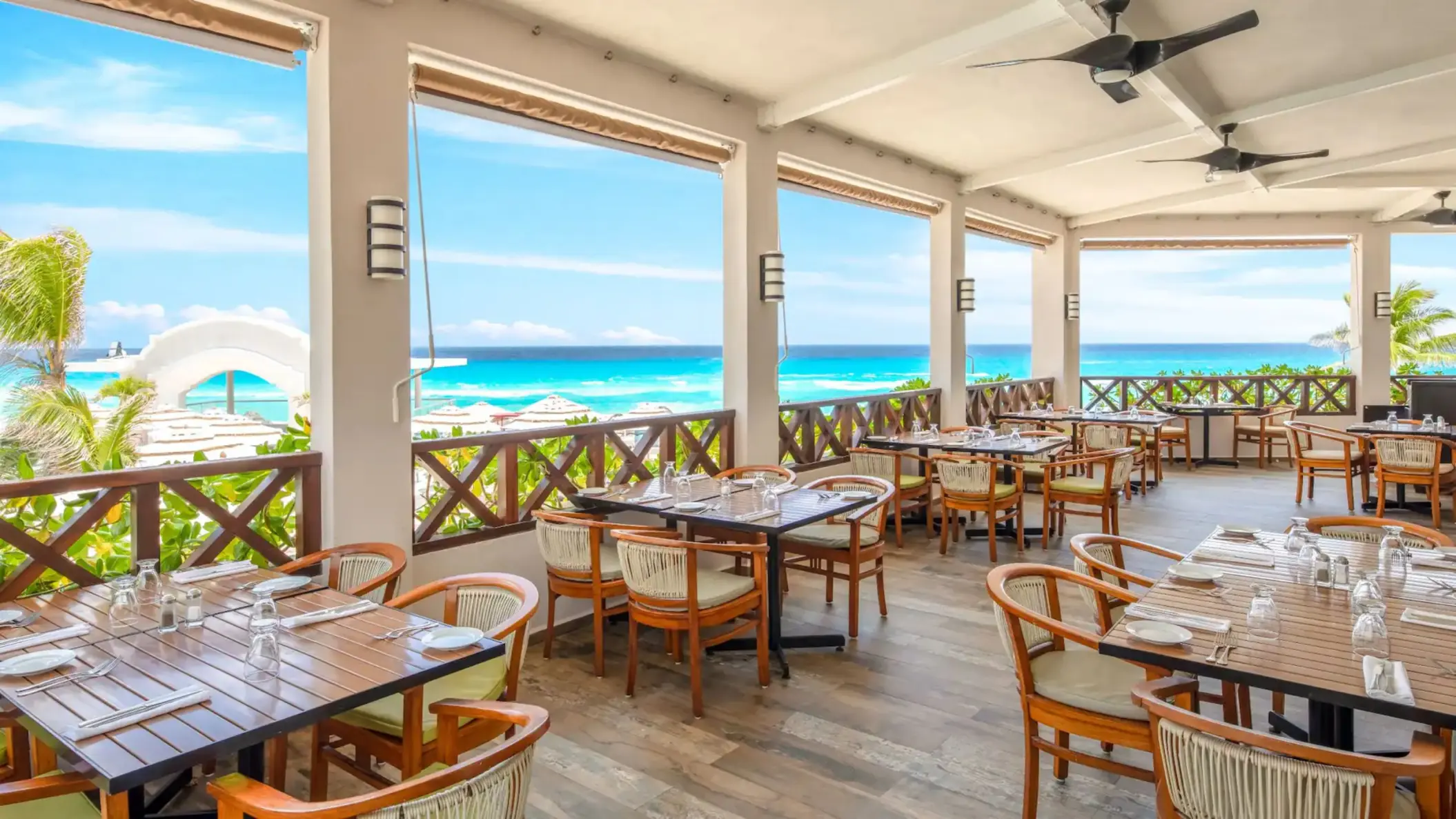 The Ventanas restaurant with outdoor seating and a stunning panoramic view of the beach and ocean.