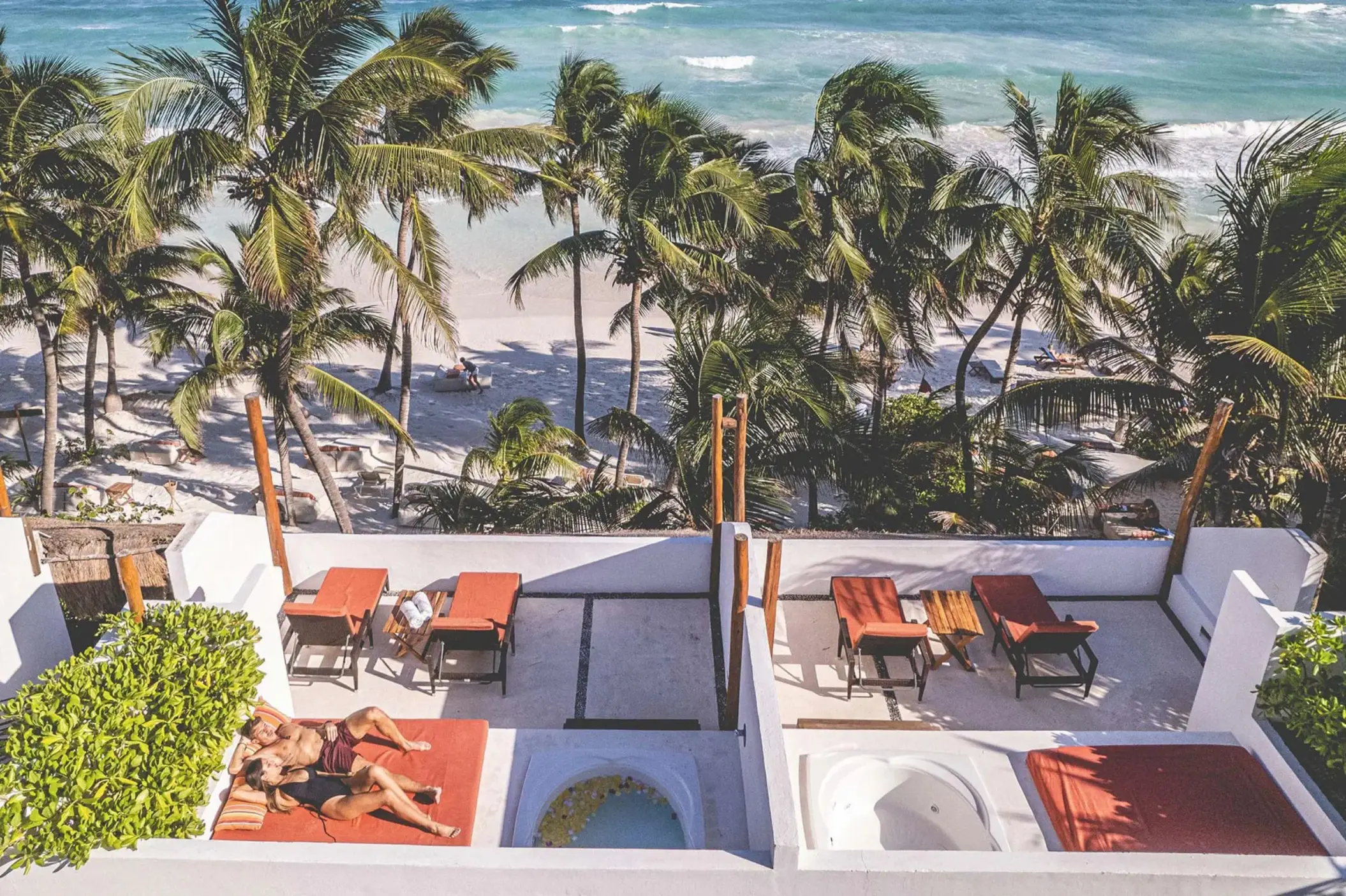 couple lounging on the terrace of their rooftop room at The Beach Tulum Hotel