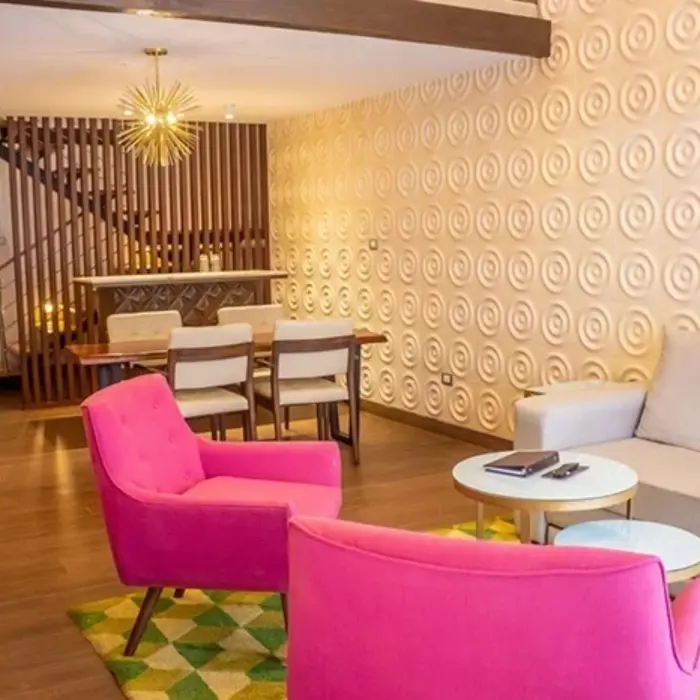 Bright suite with dining table, lounge area, and designer lighting features.