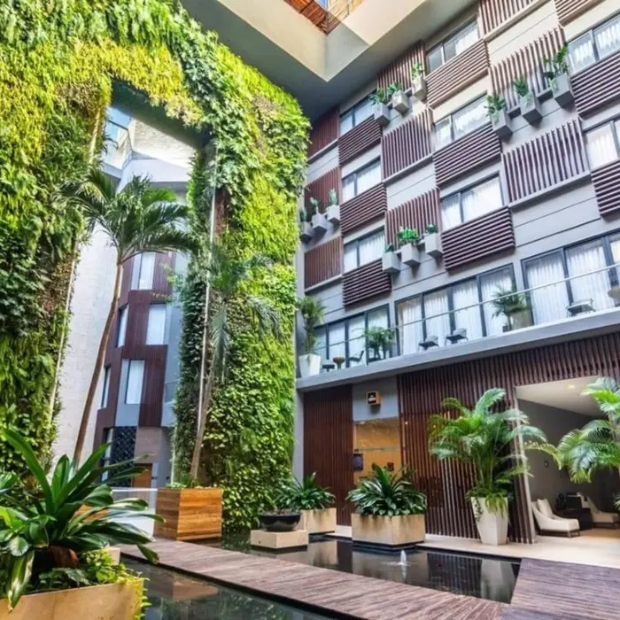 Vertical garden in an open-air courtyard with lush greenery and architectural lines at The Fives Downtown.