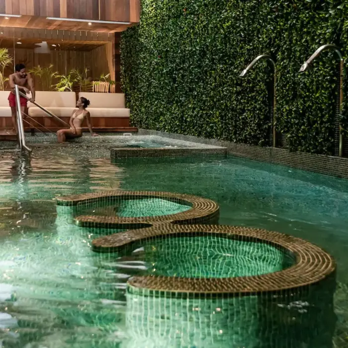 A wide shot of the serene hydrotherapy circuit pool with seating at The Reef 28's Okom Spa.