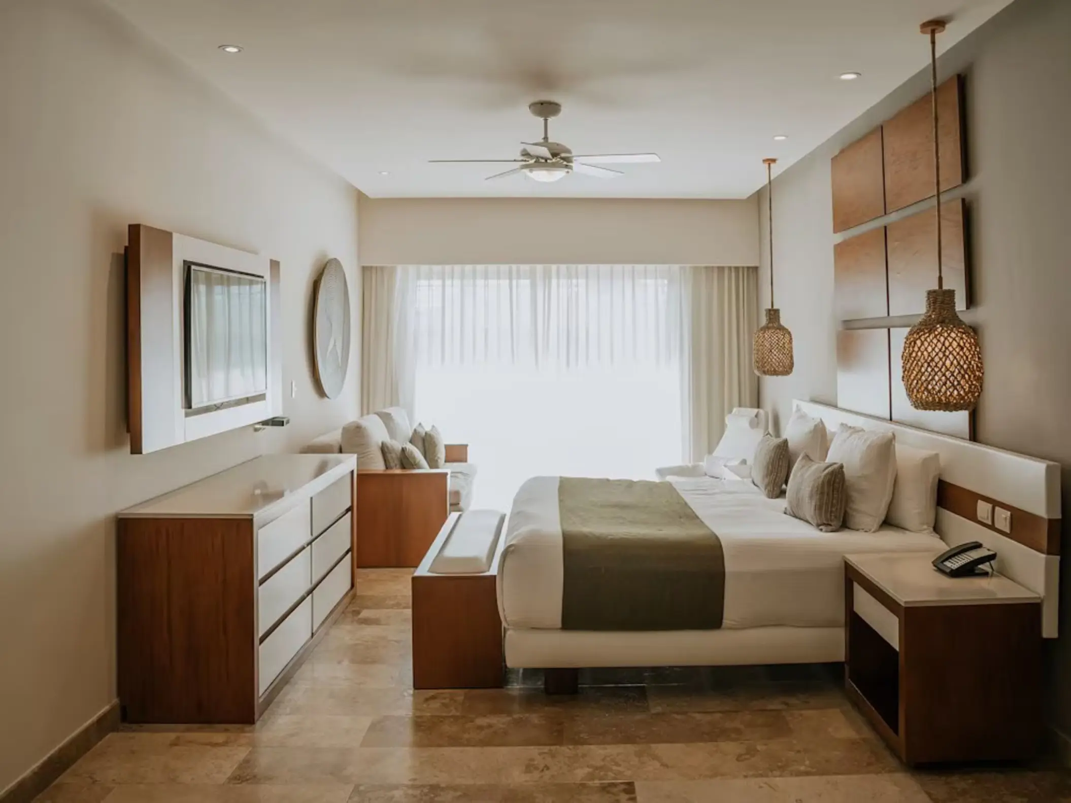 Bright and spacious master suite at The Reef 28, featuring a large bed, sitting area, and modern decor.
