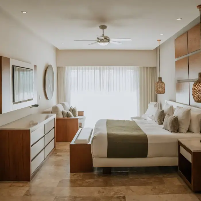 Bright and spacious master suite at The Reef 28, featuring a large bed, sitting area, and modern decor.