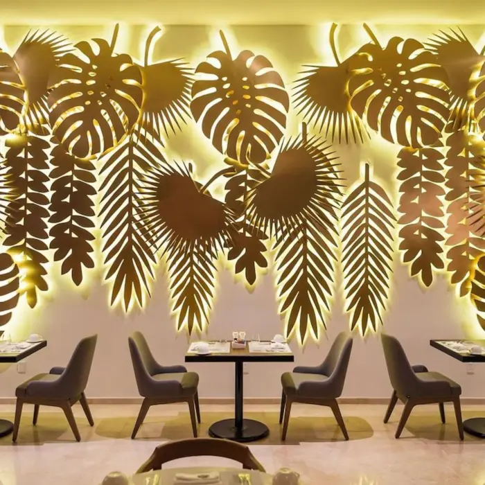 The interior of Veinti8cho buffet restaurant at The Reef 28, featuring elegant seating and decorative backlit wall art.