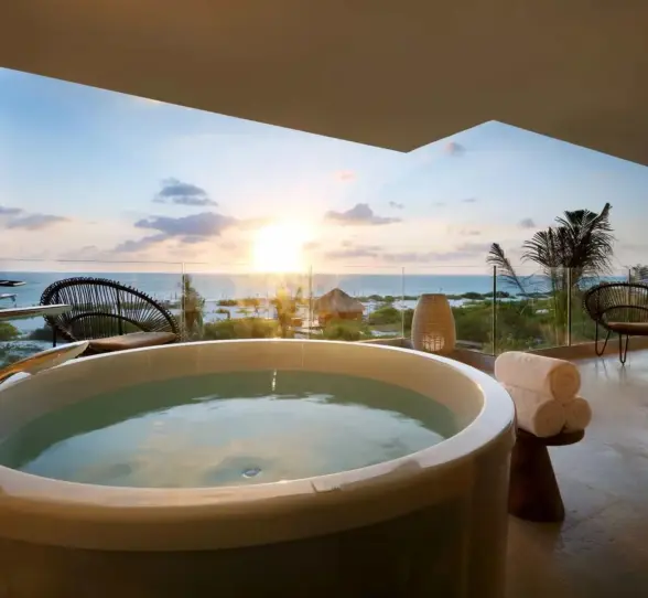 view of sunrise from balcony of a suite with hot tub at trs coral hotel