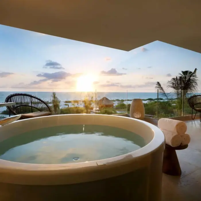 view of sunrise from balcony of a suite with hot tub at trs coral hotel