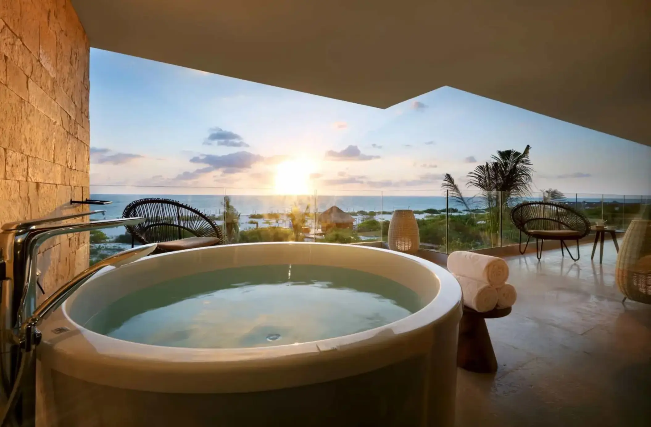view of sunrise from balcony of a suite with hot tub at trs coral hotel