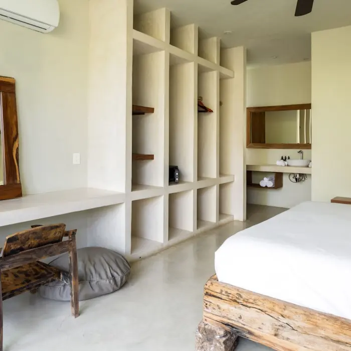 villa with king bed and rustic wooden furniture at Una Vida Tulum