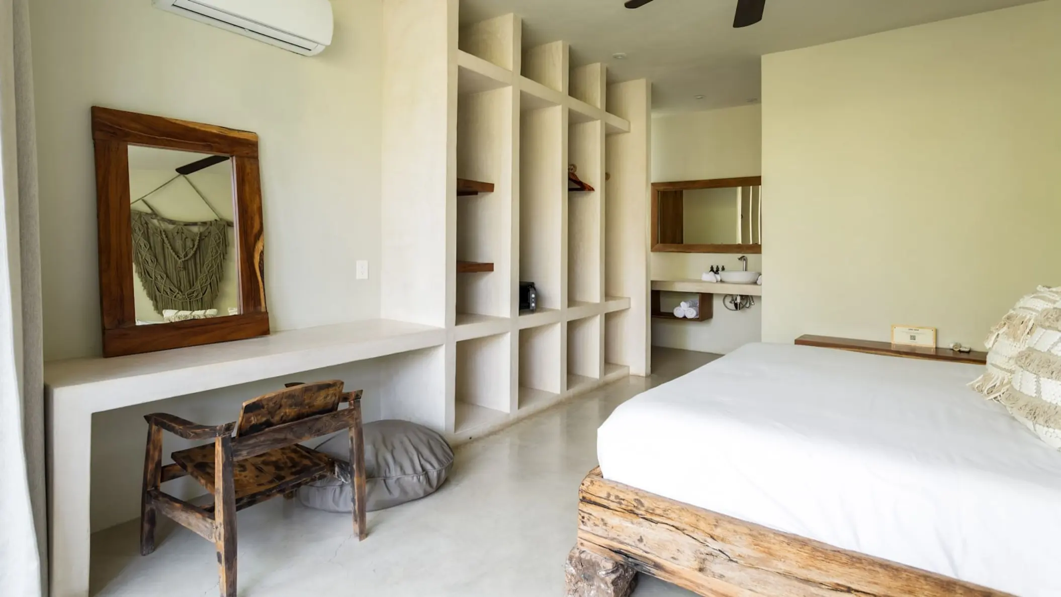 villa with king bed and rustic wooden furniture at Una Vida Tulum