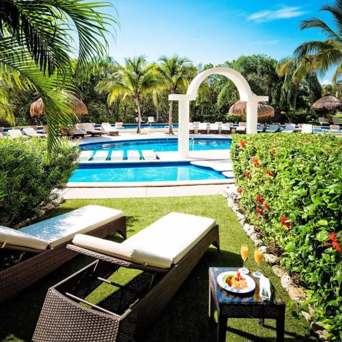 loungers by the pool at golden junior suite swim up at Valentin Imperial Riviera Maya