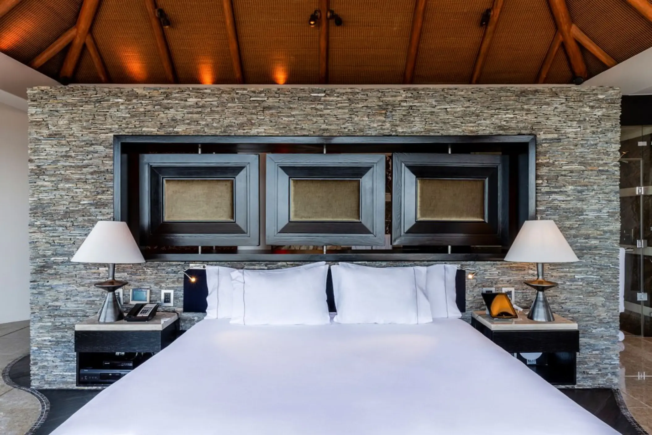 king size bed inside suite at villa del palmar cancun