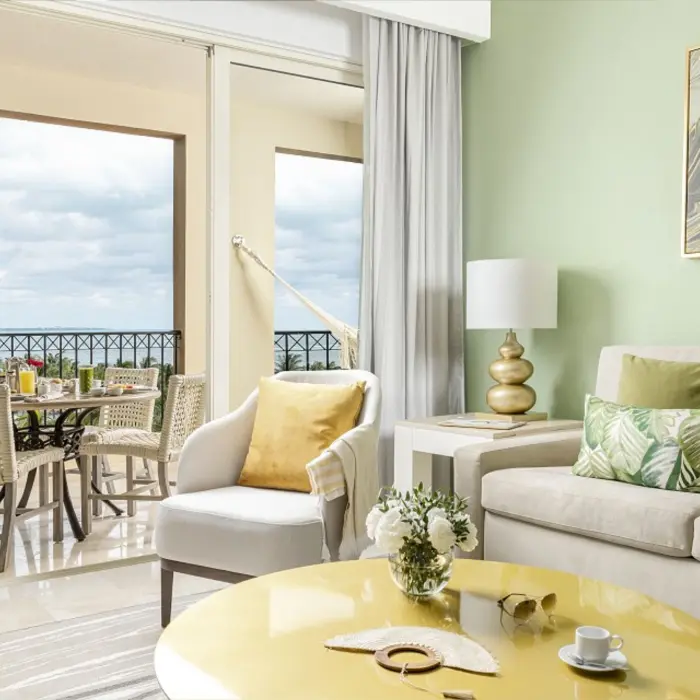 living space and balcony of suite at villa del palmar cancun