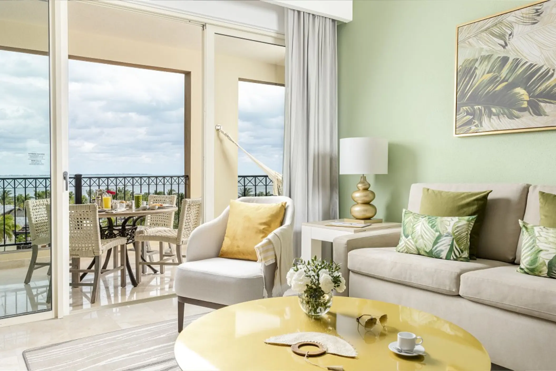 living space and balcony of suite at villa del palmar cancun