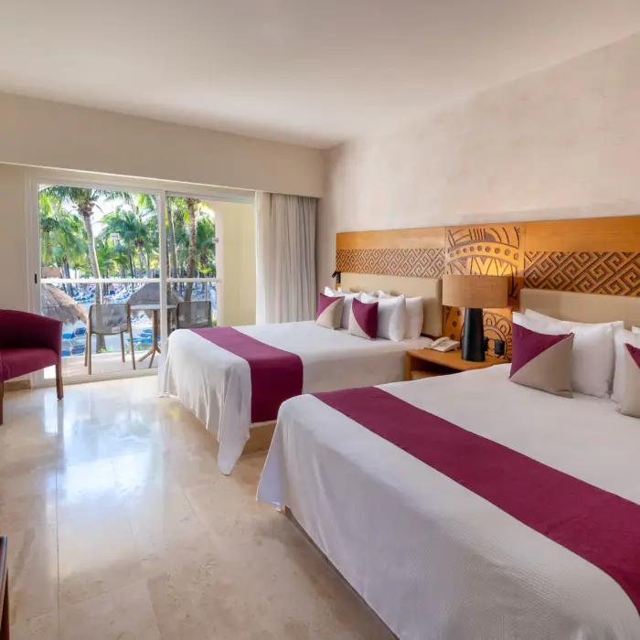 room with two queen beds and pool view at Viva Azteca by Wyndham