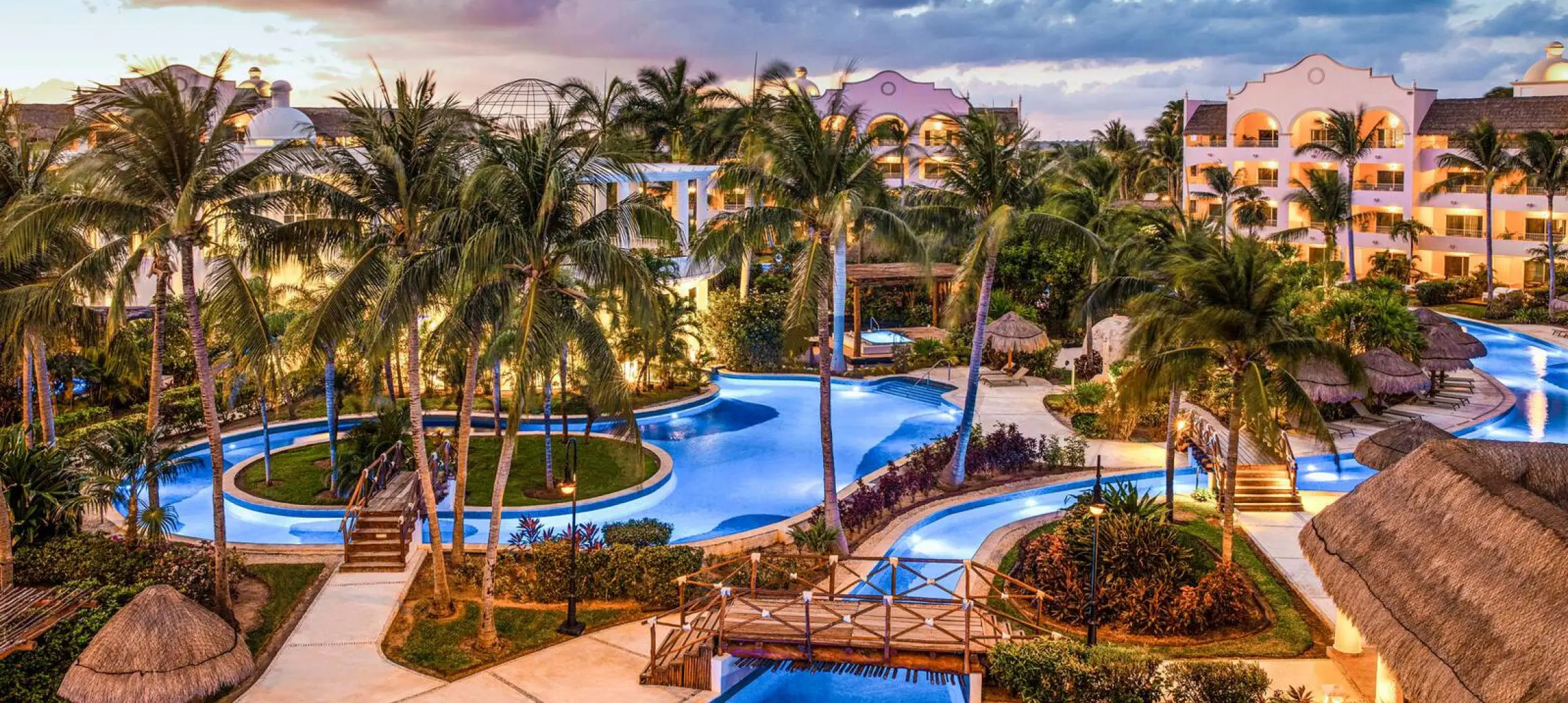 sunset over the pools at excellence riviera cancun