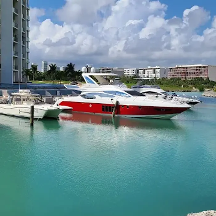 A beautiful landscape view across the bright blue water showing the manicured golf course and modern luxury condos of Puerto Cancún