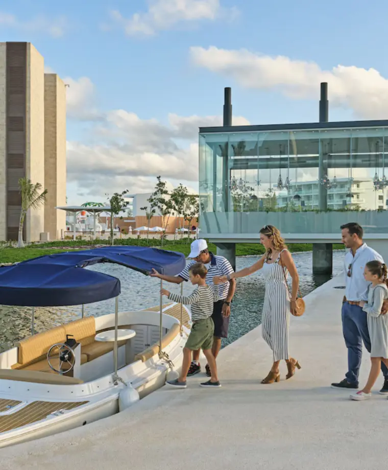 family stepping on a boat at Grand Palladium Select Costa Mujeres