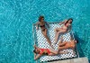 Women relax on a floating platform at Breathless Riviera Maya